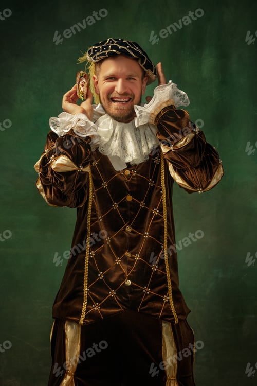 Preview: Trying New. Portrait Of Medieval Young Man In Vintage Clothing With Wooden Frame On Dark