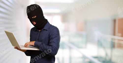 Preview: Young Male Thief Holding Laptop, Indoor