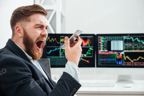 Preview: Angry Irritated Bearded Young Businessman Screaming In Smartphone In Office