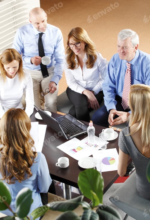 Preview: High Angle View Of Financial Business People Sitting At Meeting. Businesswomen And Businessmen
