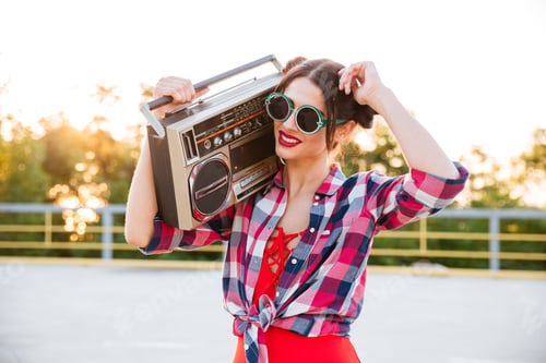 Preview: Young Pretty Brunette Girl In Sunglasses And Red Swimsuit Holding Old Record Player On The Open