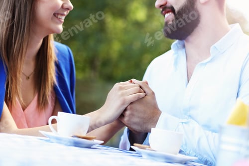 Preview: Picture Of Romantic Couple Holding Hands In Cafe