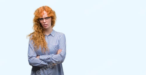 Preview: Young Redhead Bussines Woman Skeptic And Nervous, Disapproving Expression On Face With Crossed