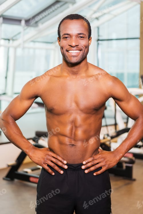 Preview: Strong And Healthy. Confident Young African Man Holding Hands On Hip And Smiling While Standing In