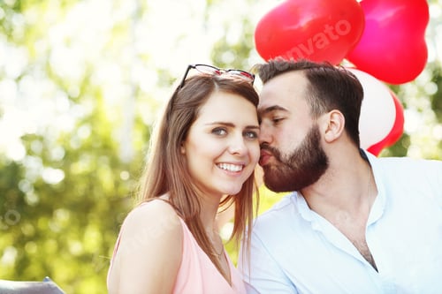 Preview: A Picture Of Romantic Couple Standing Outside With Baloons
