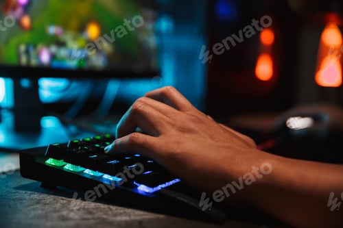 Preview: Hands Of Professional Gamer Man Playing Video Games On Computer In Dark Room Using Backlit Colorful