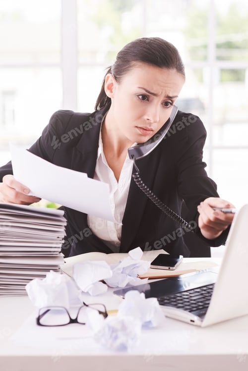 Preview: Busy Office Life. Frustrated Young Woman In Formalwear Talking On The Telephone And Holding