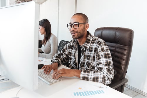Preview: Photo Of Young Concentrated Business Couple Using Computers In Office. Look At Computers.