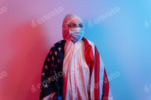 Preview: Save The United States From The Coronavirus Pandemic. Doctor Wearing A Covid-19 Protective Suit