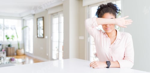 Preview: Wide Angle Of Beautiful African American Woman With Afro Hair Covering Eyes With Arm, Looking