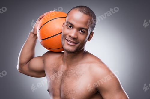 Preview: Ready For A Game. Young Shirtless African Man Holding Basketball Ball And Looking At Camera While