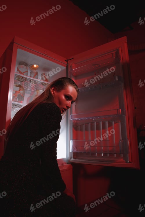 Preview: Side View Of Mystery Woman In Dress Which Standing Near The Fridge And Looking Away. Conceptual