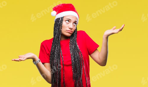 Preview: Young Braided Hair African American Girl Wearing Christmas Hat Over Isolated Background Clueless