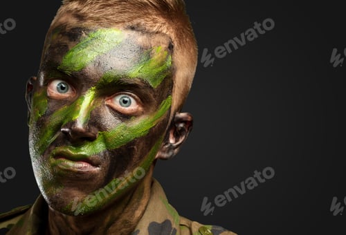 Preview: Closeup Of Angry Soldier With Painting Against A Black Background