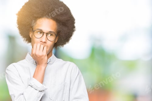 Preview: Young African American Man With Afro Hair Wearing Glasses Looking Stressed And Nervous With Hands