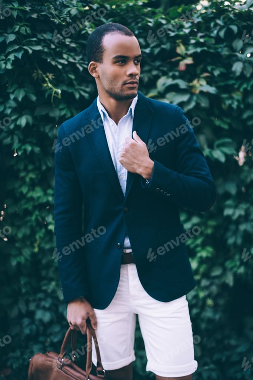 Preview: Confident In His Style. Handsome Young African Man In Smart Casual Wear Carrying Bag And Looking