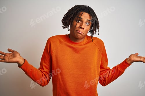 Preview: Afro American Man With Dreadlocks Wearing Orange Sweater Over Isolated White Background Clueless