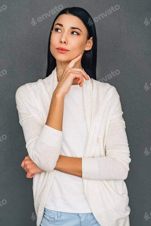 Preview: Thoughtful Beauty. Beautiful Young Pensive Woman Keeping Hand On Chin And Looking Away While