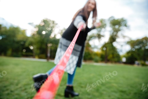 Preview: Happy Pretty Young Woman Running And Playing With Her Dog On Lead In Park