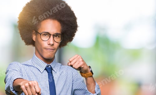 Preview: Young African American Business Man With Afro Hair Wearing Glasses Punching Fist To Fight