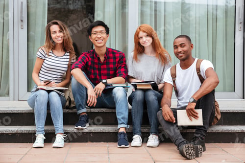 Preview: Multiethnic Group Of Happy Young People Sitting In Campus Together