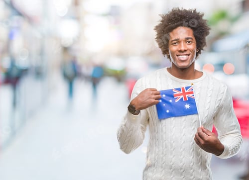 Preview: Smiling Man Holding an Australian Flag Outdoors
