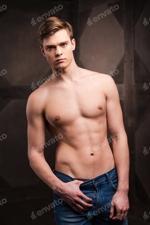 Preview: Confident In His Perfect Body. Handsome Young Muscular Man Posing While Standing Against Metal