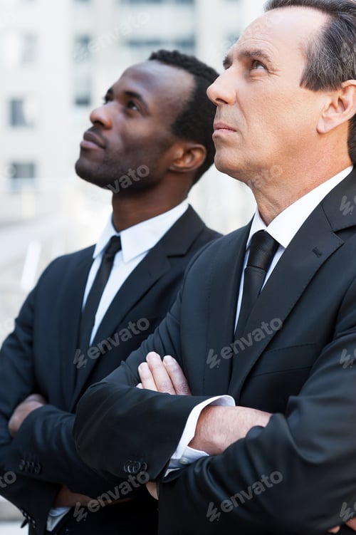 Preview: Looking For New Solutions. Side View Of Two Confident Businessmen Keeping Arms Crossed And Looking