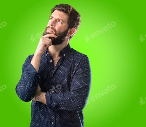Preview: Young Hipster Man With Big Beard Thinking And Looking Up Expressing Doubt And Wonder Over Green