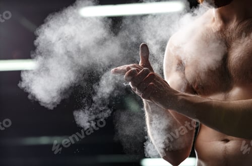 Preview: Cropped Image Of Handsome Sports Man In Gym Rubbing Hands With Chalk