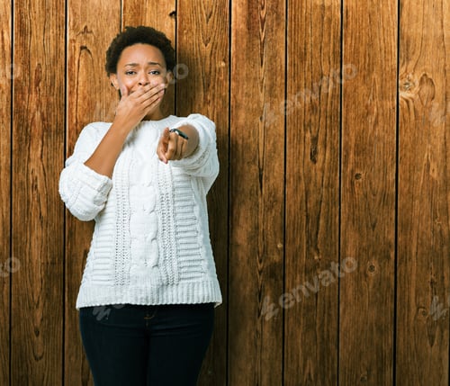 Preview: Beautiful Young African American Woman Wearing Sweater Over Isolated Background Laughing Of You