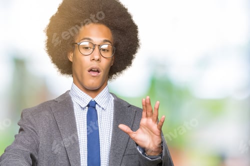 Preview: Young African American Business Man With Afro Hair Wearing Glasses Afraid And Terrified With Fear