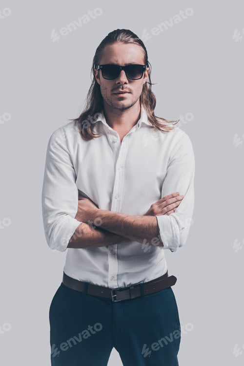Preview: Cool And Handsome. Handsome Young Man In White Shirt And Sunglasses Looking At Camera And Keeping