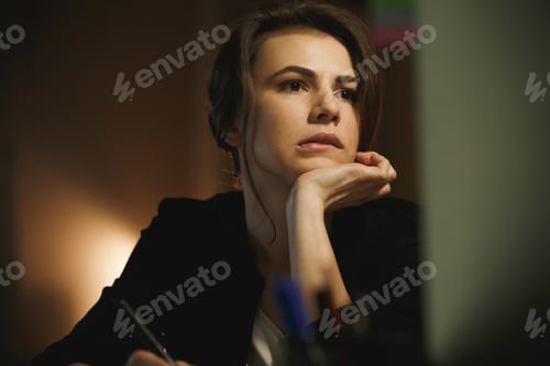 Preview: Picture Of Serious Young Lady Designer Sitting In Office At Night Using Computer And Graphic