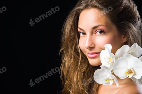 Preview: Gorgeous Brunette Closeup Beauty Shot With White Orchid.