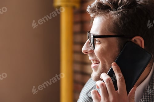 Preview: Close Up Side View Of Smiling Business Man In Eyeglasses Sitting By The Table In Cafe And Talking