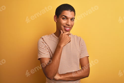 Preview: Young Handsome Arab Man Wearing Striped T-Shirt Standing Over Isolated Yellow Background Looking