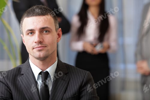 Preview: Handsome Executive Businessman With His Team Working Behind