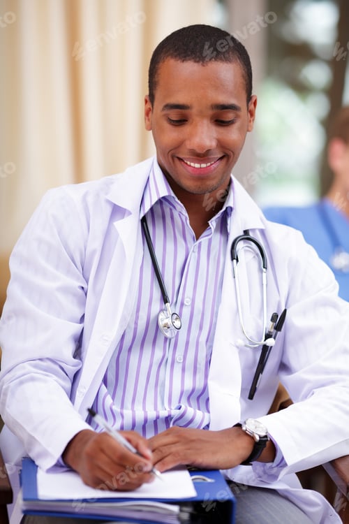 Preview: Smiling African-American Doctor Making Notes In A Patient'S Folder