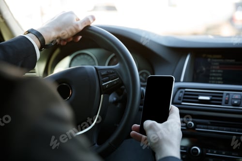 Preview: Close Up Of A Man Using Mobile Phone While Driving His Car