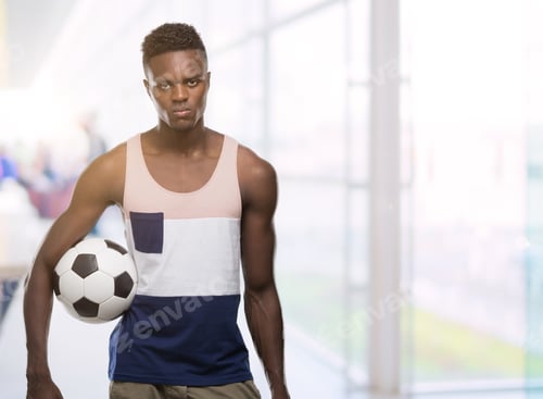 Preview: Young African American Man Holding Soccer Football Ball With A Confident Expression On Smart Face