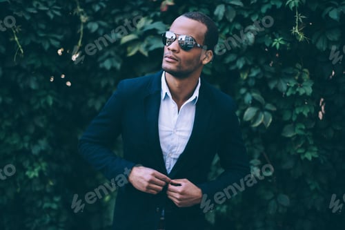 Preview: Used To Look Perfect. Handsome Young African Man In Sunglasses Adjusting His Smart Casual Jacket