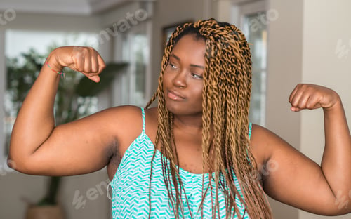 Preview: African American Woman At Home Showing Arms Muscles Smiling Proud. Fitness Concept.
