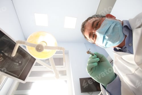 Preview: Close-Up Portrait From Bottom Of A Dentist During A Routine Checkup At Dentist Office. Personal