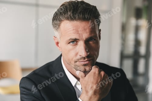 Preview: Portrait Closeup Of Handsome Businessman Wearing White Shirt And Black Suit Touching Chin And
