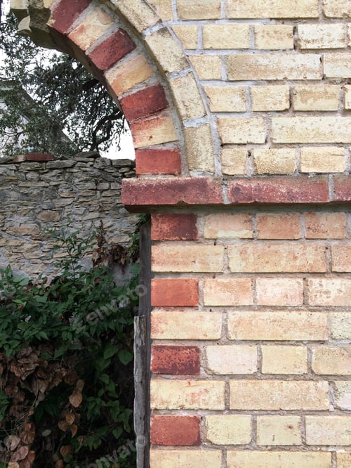 Preview: Brick Wall Arched Doorway With Red And Tan Bricks - Portrait Color Photo