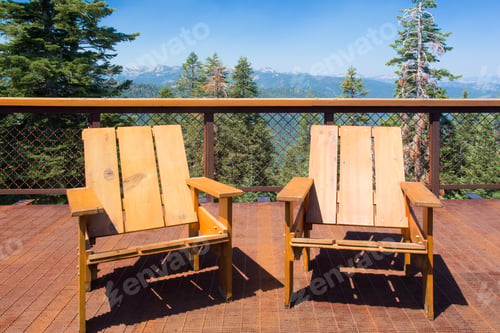 Preview: Two Wood Chairs On Outdoor Sunny Deck With Mountains In The Background