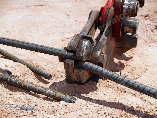 Preview: A Close-Up Photo Of A Rebar Cutting Tool Slicing Through A Piece Of Iron Rebar. It Is A Common Tool