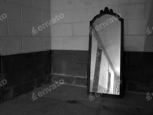 Preview: An Old Mirror Lying Against A Basement Wall Apparently Forgotten.
