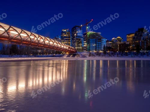 Preview: Calgary Skyline In Winter Provides A Backdrop To The Frozen Bow River.